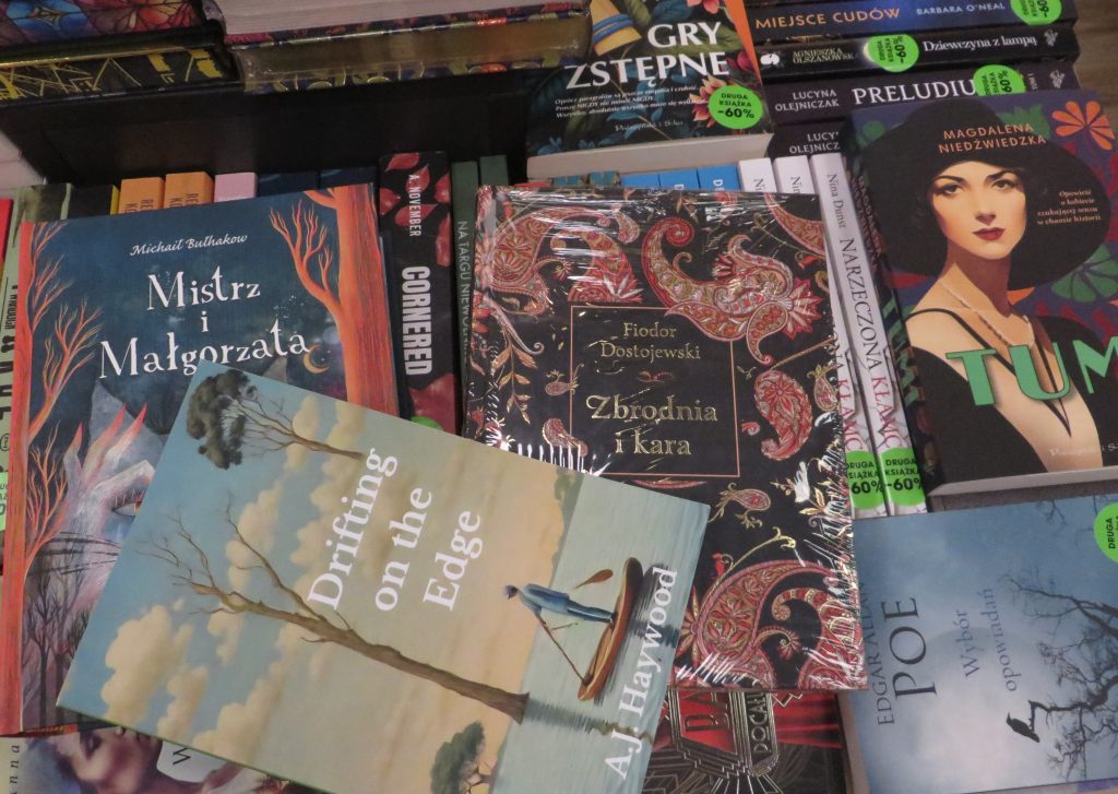 Picture of author's novel among other novels in Polish bookstore